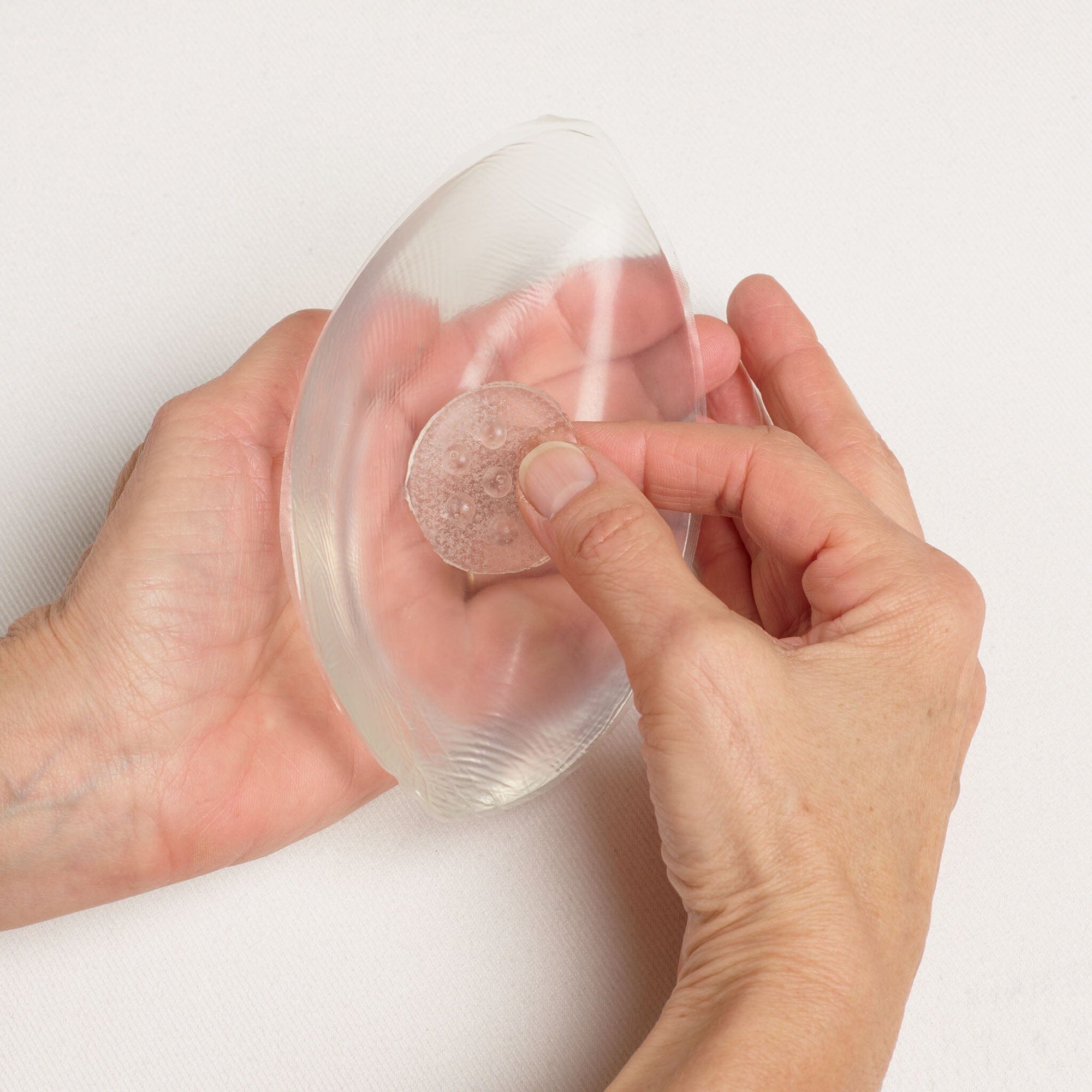 Breathable Adhesive Mastectomy Disc shown in a breast form.