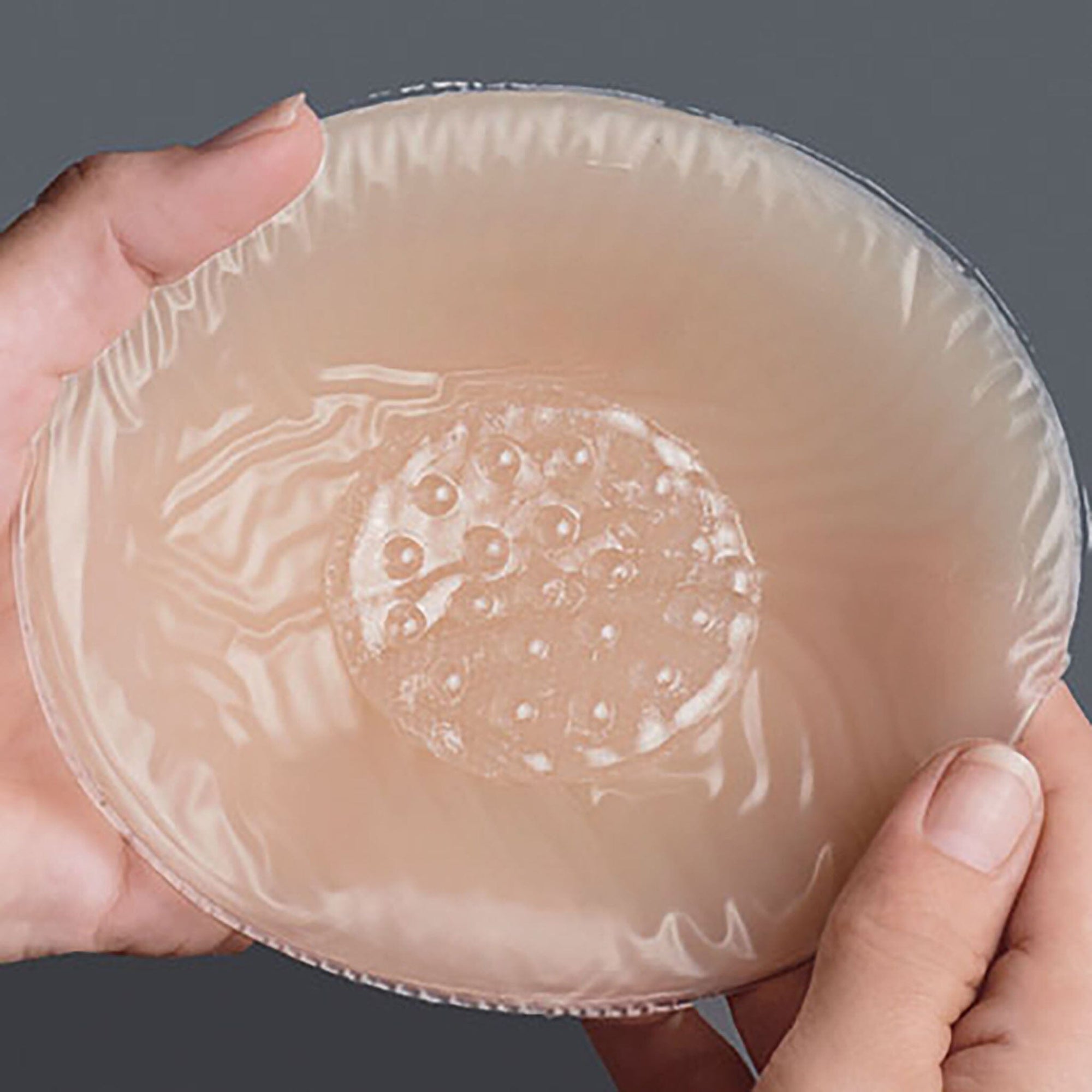 Breathable Adhesive Mastectomy Disc shown in a breast form.